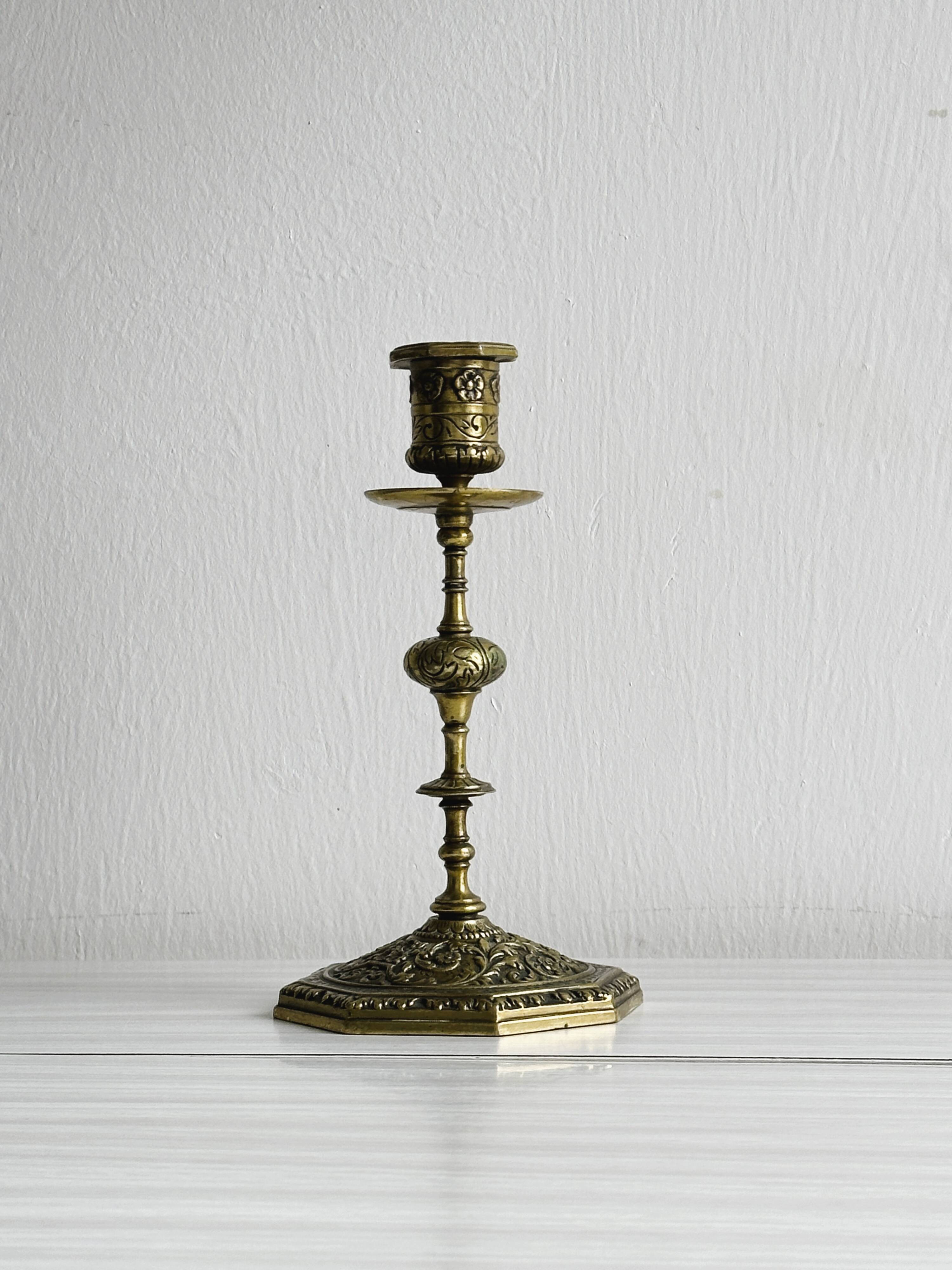 Carved brass candlestick holder