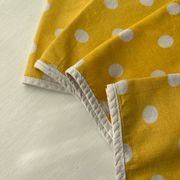 4 yellow napkins with white polka dots