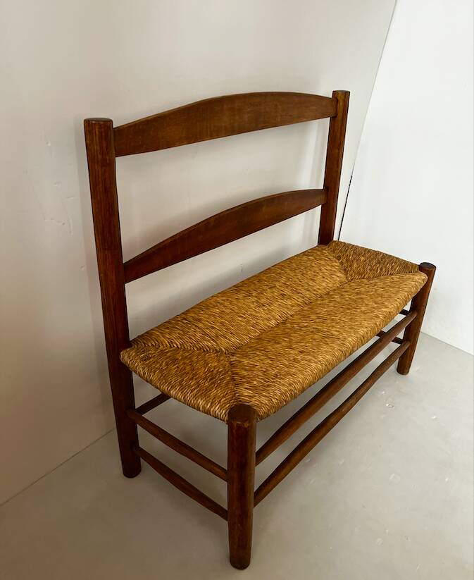 Old wooden and straw bench