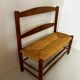 Old wooden and straw bench
