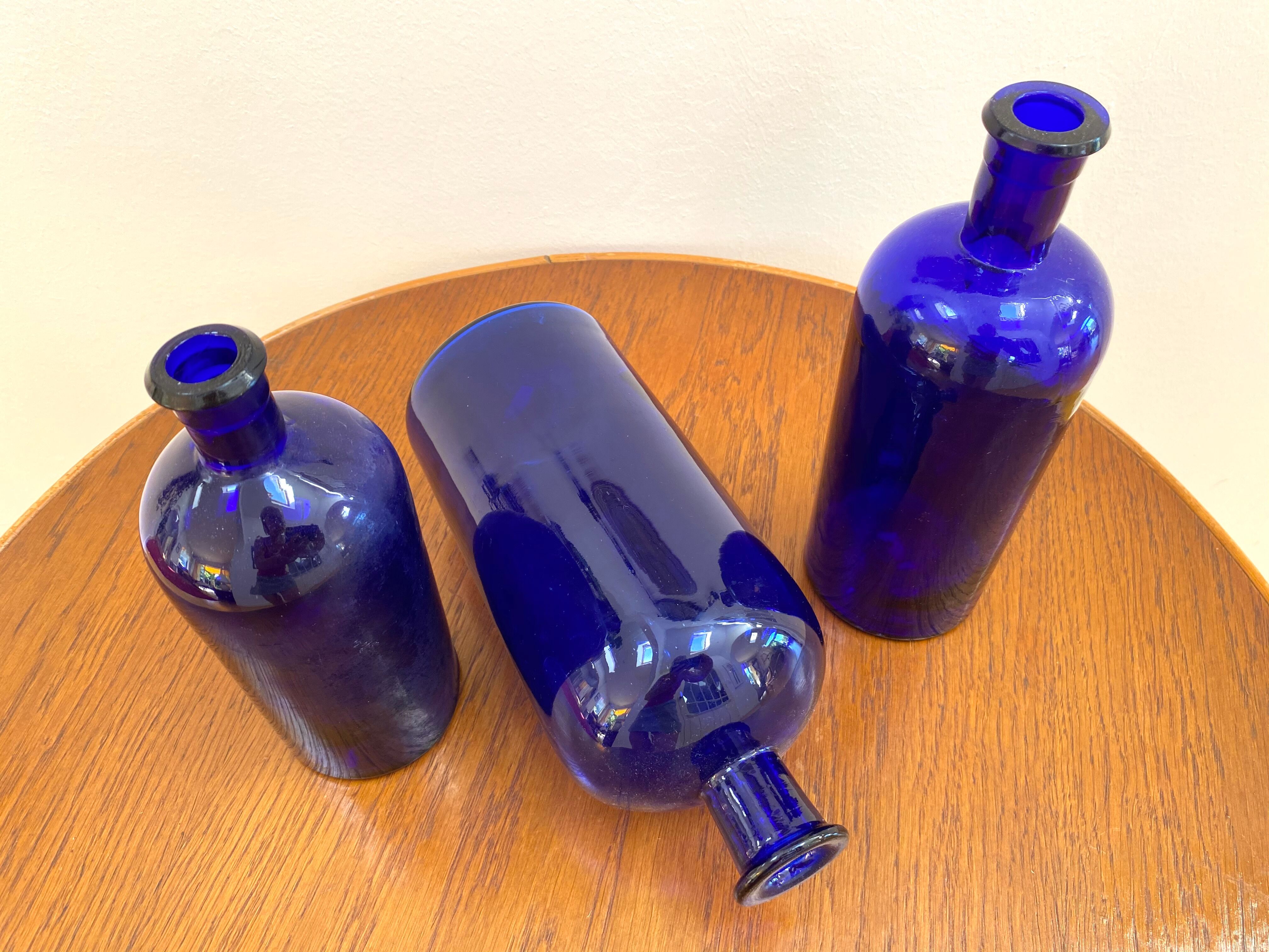 Trio of apothecary bottles in cobalt blue glass