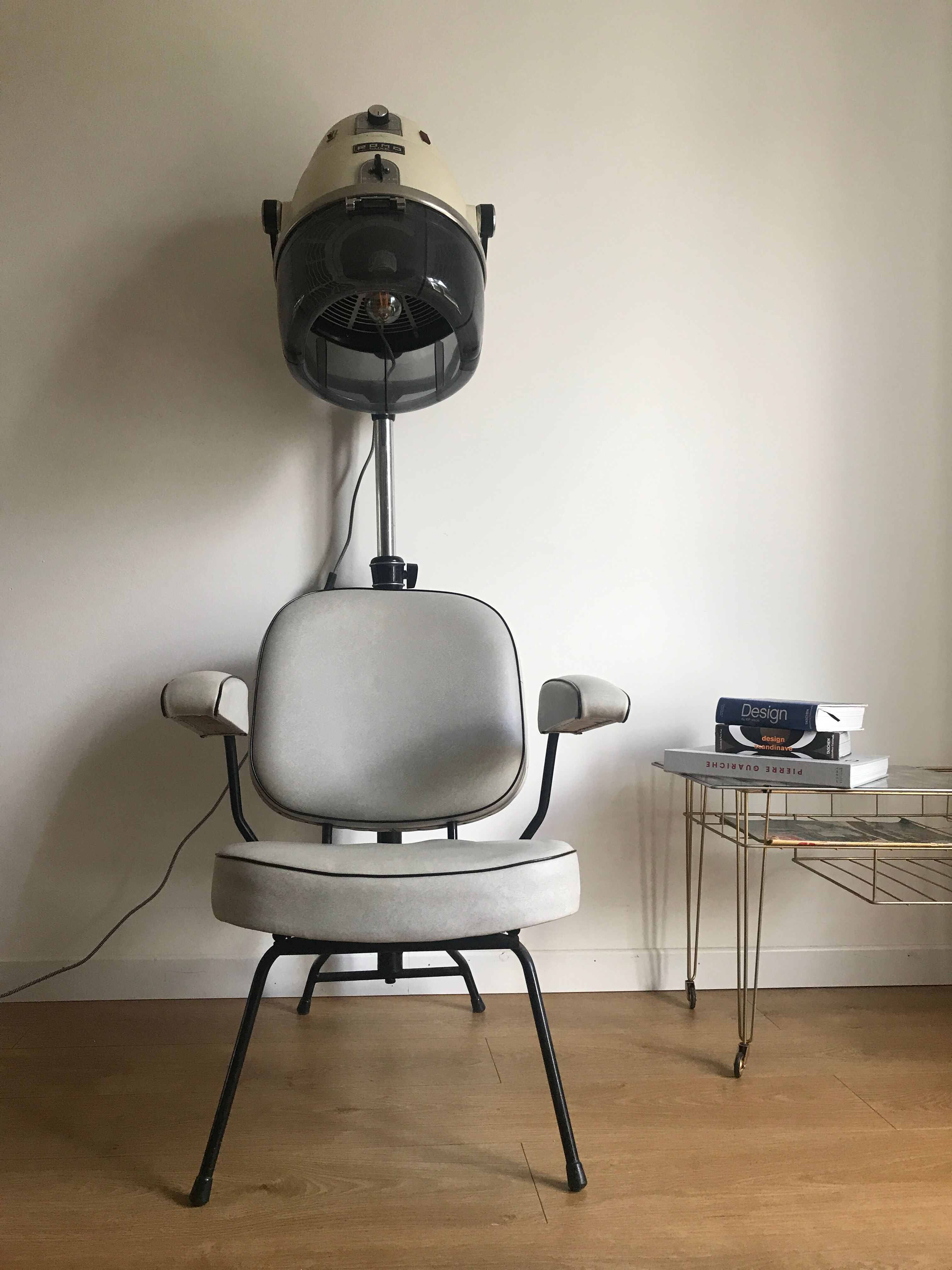Vintage hairdresser's armchair with helmet transformed into a lamp