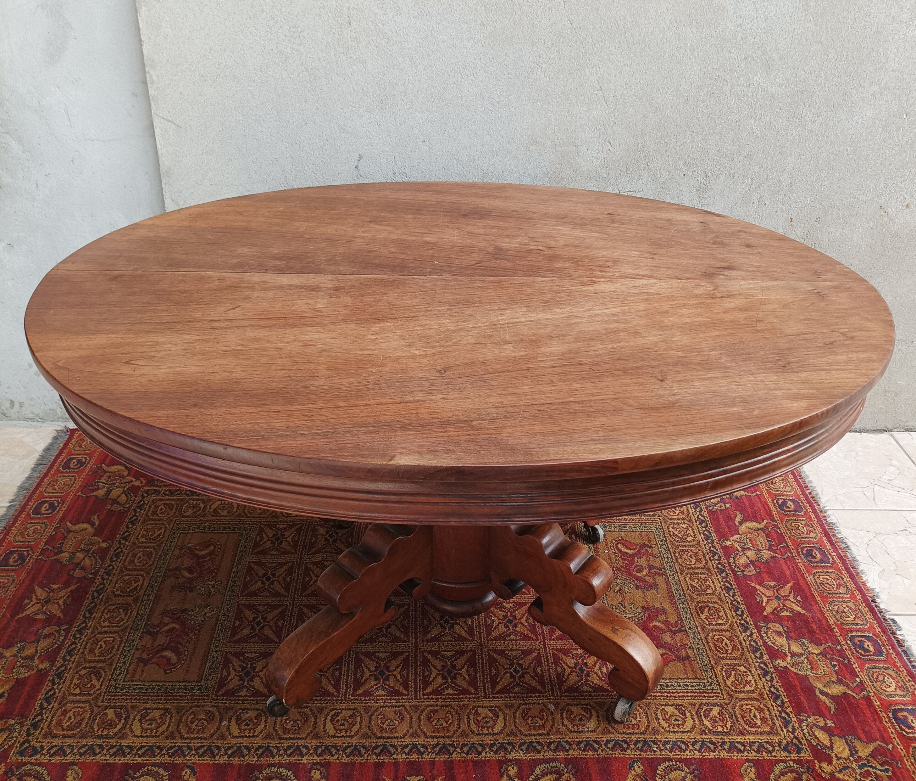 English oval table with 19th century mahogany extensions