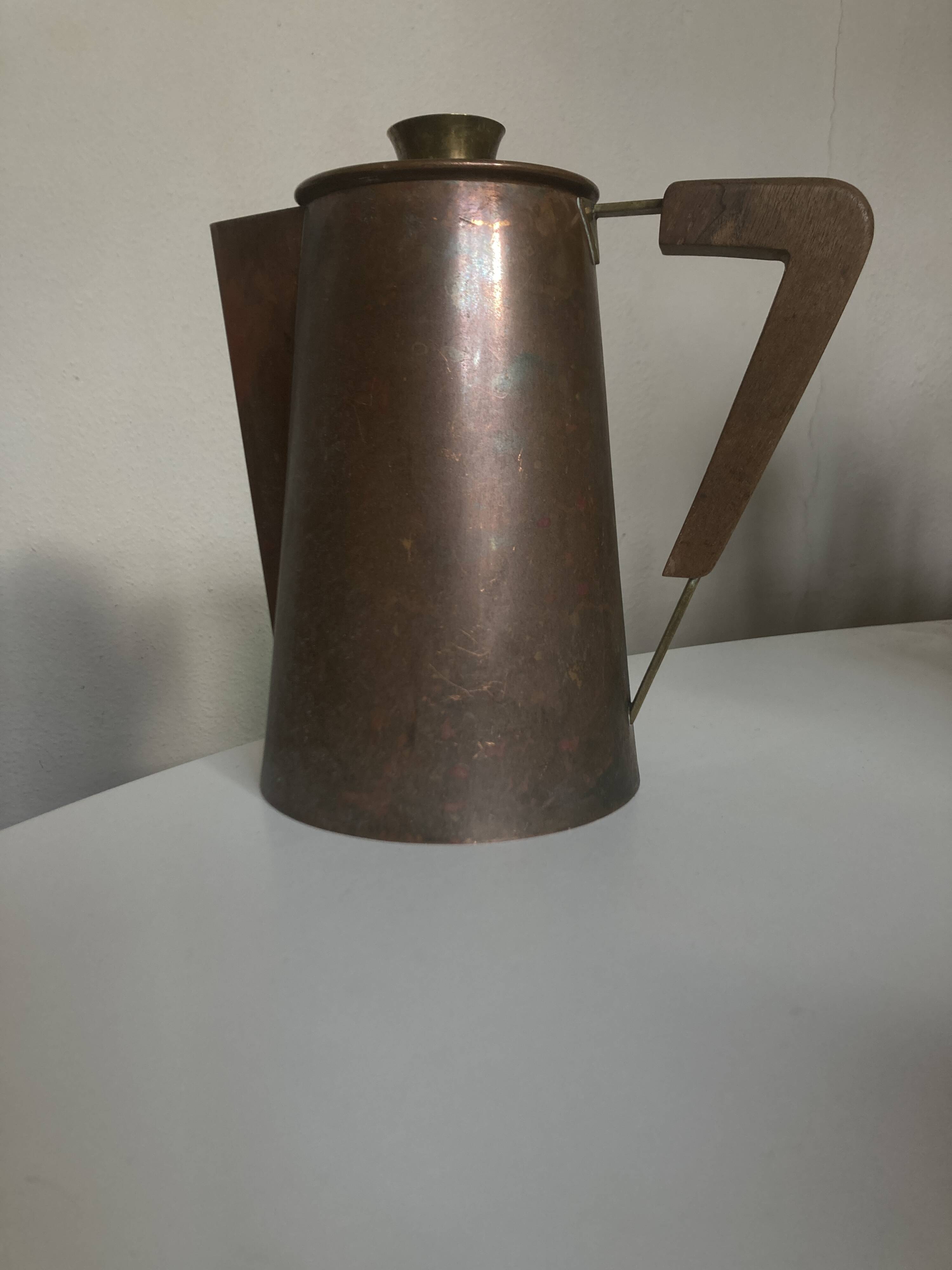 Modernist Italian pitcher design from the 1960s in patinated wood and metal.