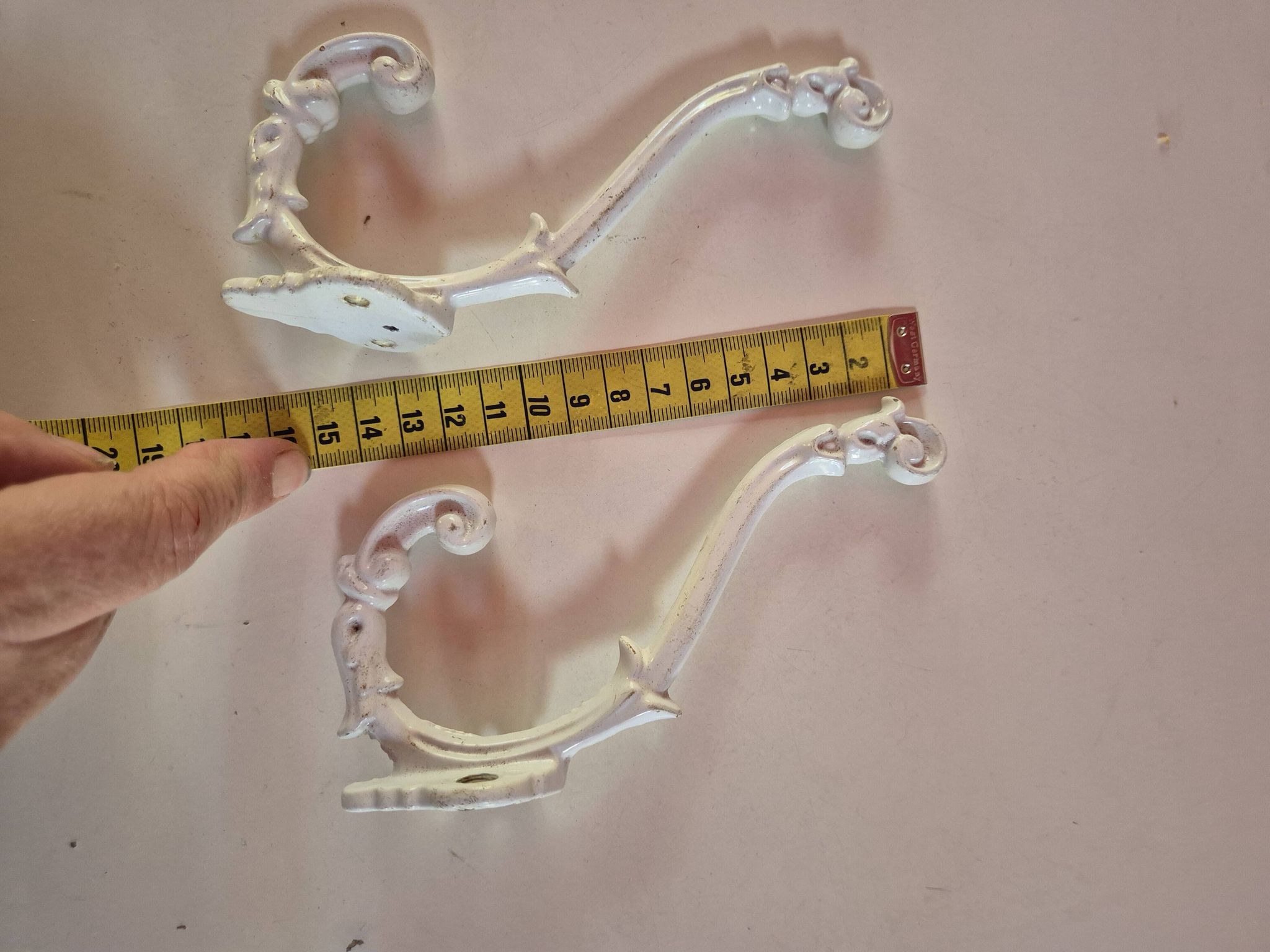 set of 2 vintage white cast iron hooks, small paint chips from the year