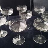 8 vintage glass champagne coupes with an engraved frieze decoration.