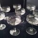 8 vintage glass champagne coupes with an engraved frieze decoration.