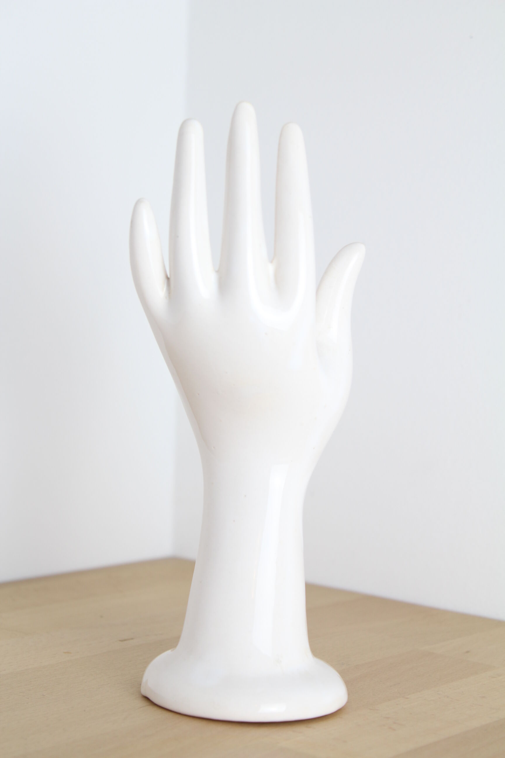 White hand ceramic ring sizer doilies