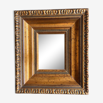 Mirror in gilded molded wood