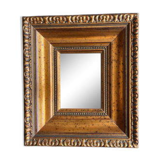 Mirror in gilded molded wood