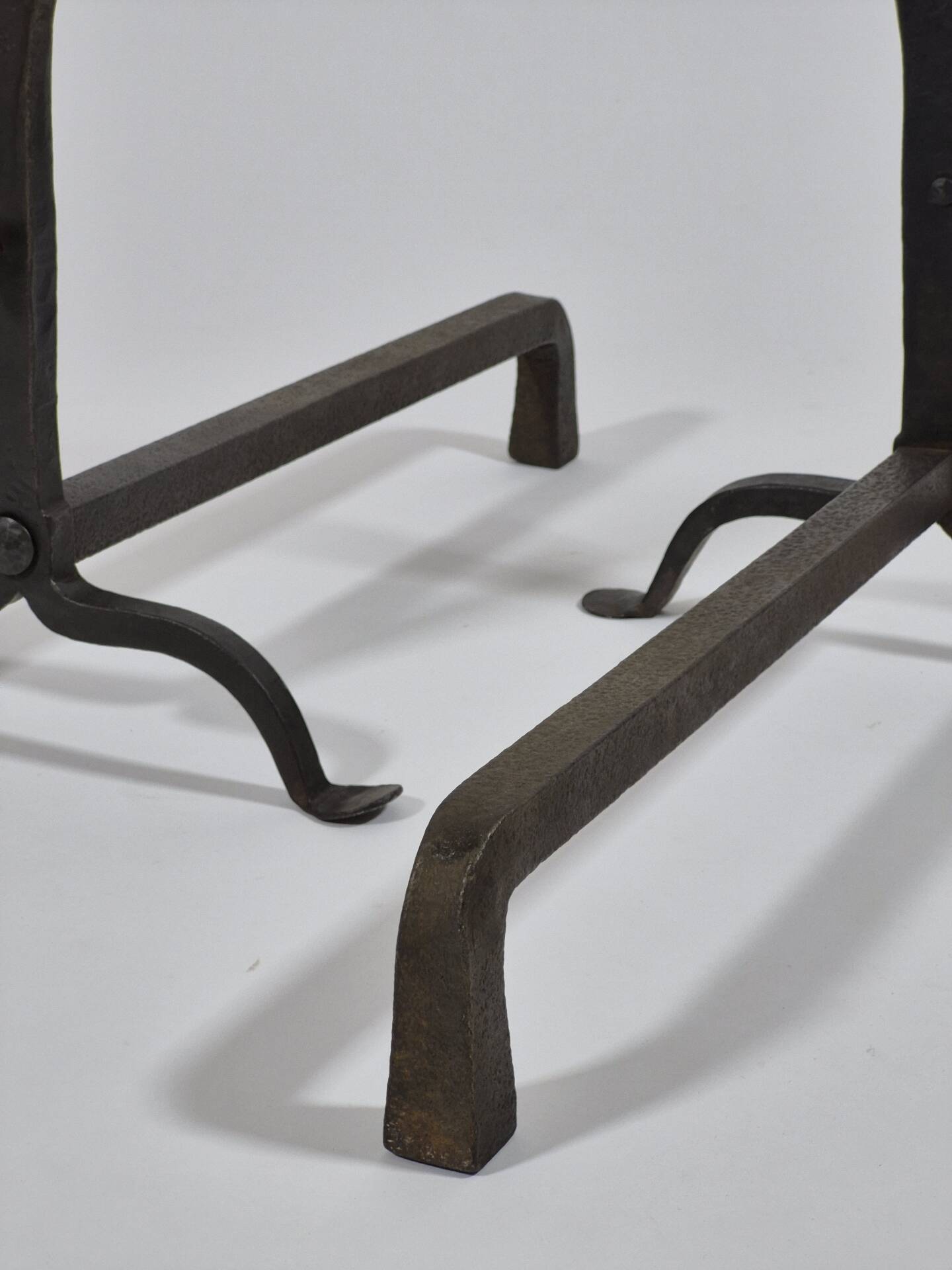 Pair of handforged metal and brass andirons