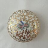 White and golden pill box with a blue bird