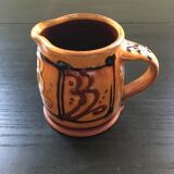 Hand decorated terracotta pitcher