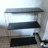 String shelf in gold and black metal