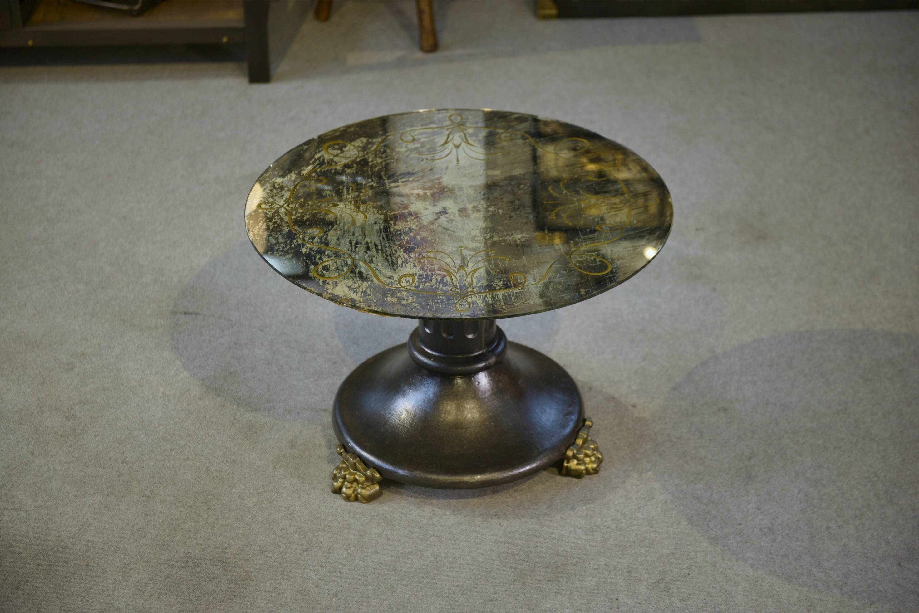 Neo-classical cast iron and glass eglomisé coffee table from the 1940s.
