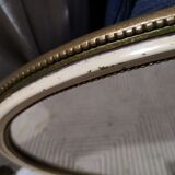 Old oval guilloche mirror, gilded and painted