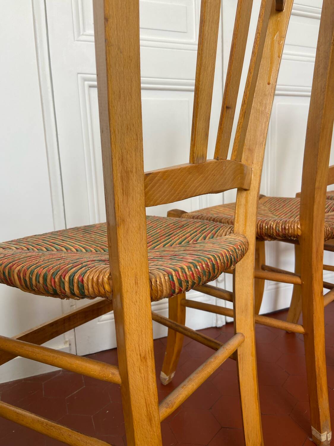 Trio of vintage straw/colored chairs