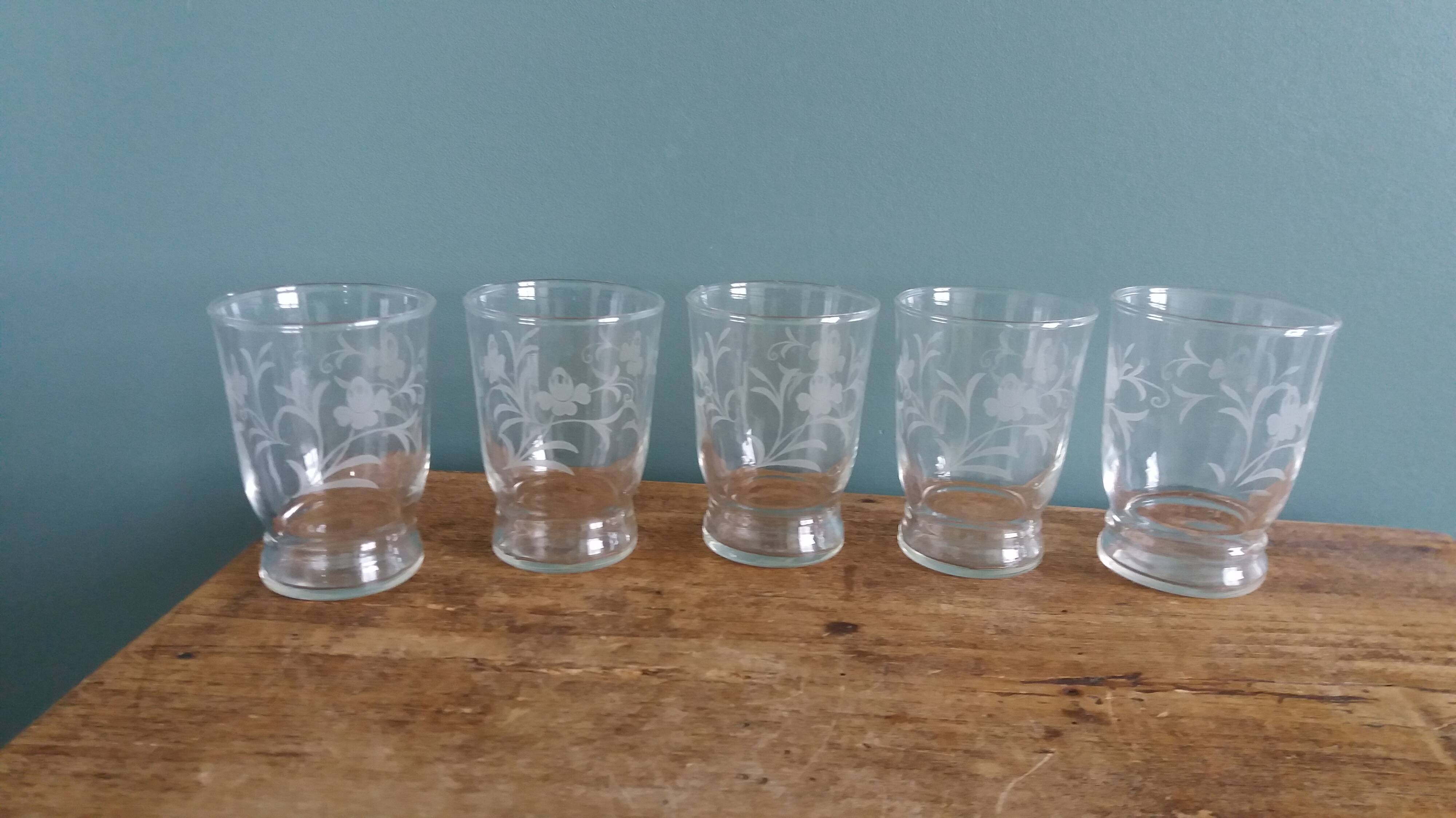 Old digestif or liqueur glasses, handcrafted glass with a floral pattern.