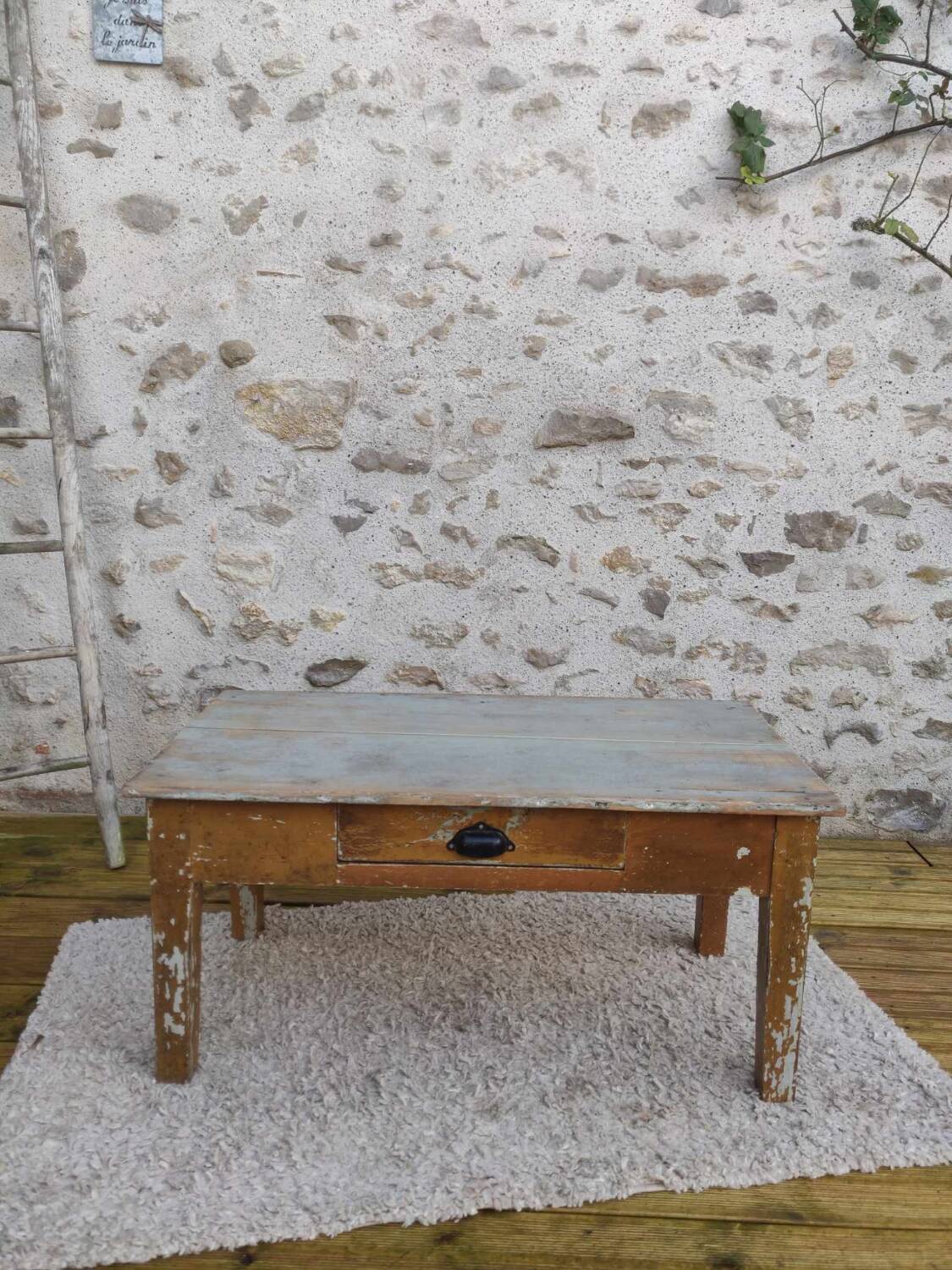 Patinated coffee table with a drawer