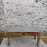 Patinated coffee table with a drawer