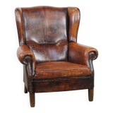 Cognac-colored vintage sheep leather wingback chair with character