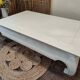Exotic wood coffee table with its safety glass protection.