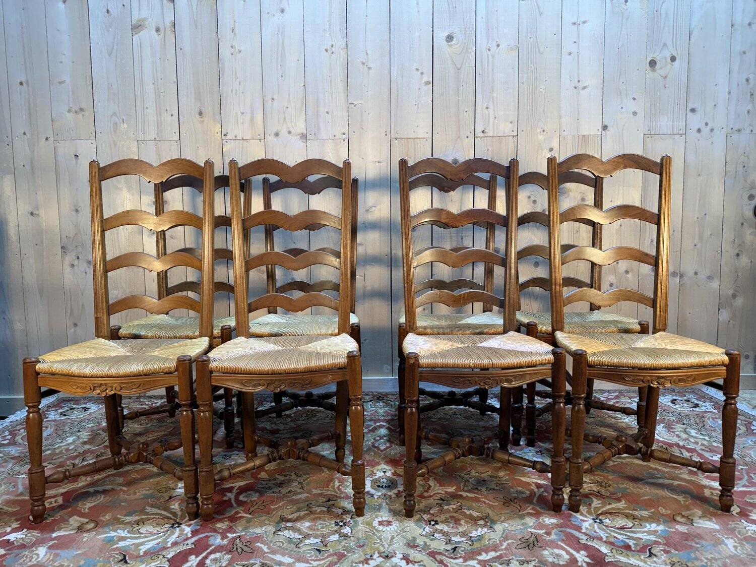 Set of 8 rustic high-back straw chairs.