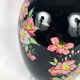 Black opal vase decorated with flowers