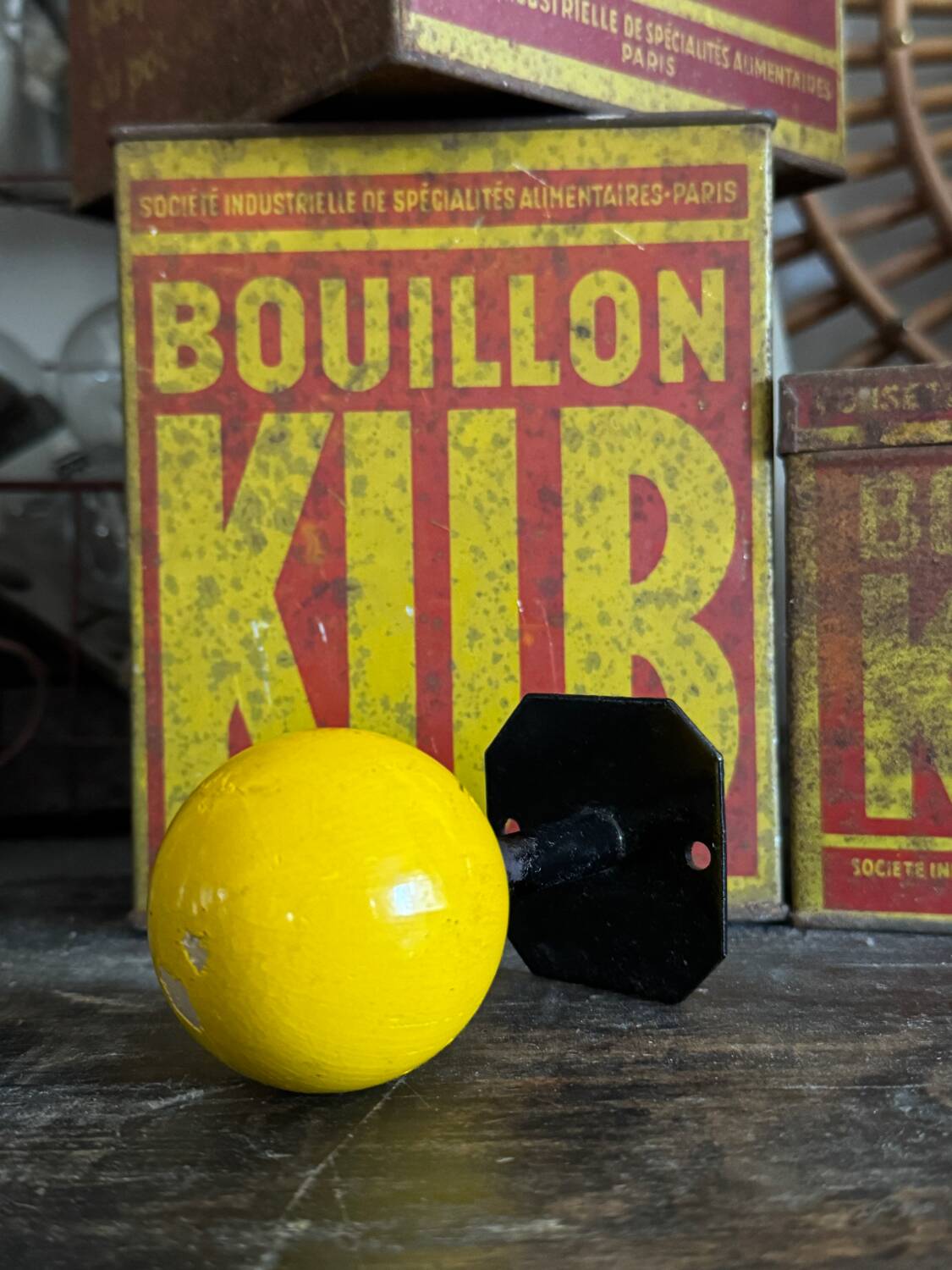 Vintage yellow wooden wall-mounted ball coat hook.