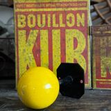 Vintage yellow wooden wall-mounted ball coat hook.