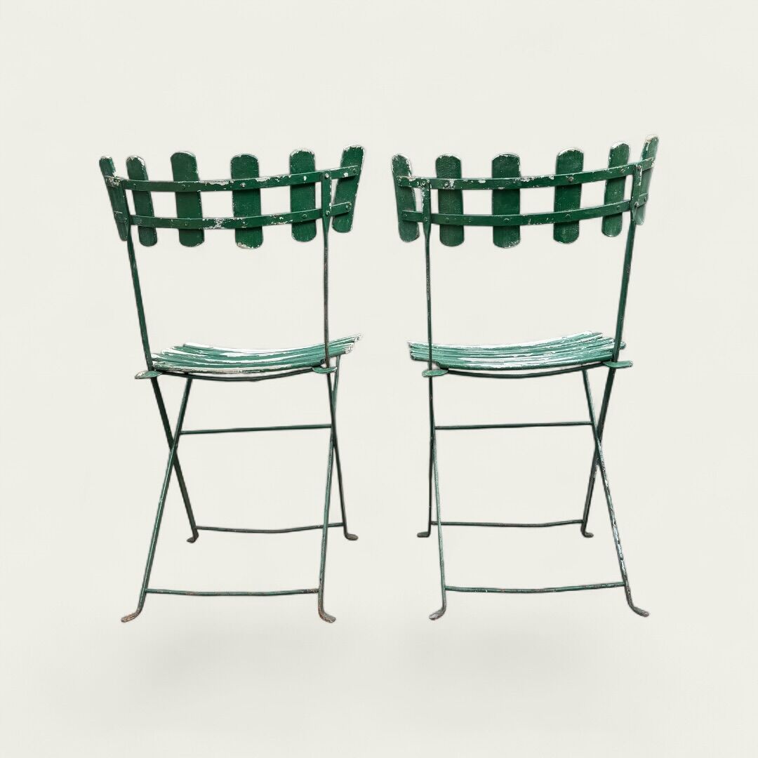 Pair of original patinated folding Parisian bistro chairs.