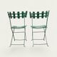 Pair of original patinated folding Parisian bistro chairs.