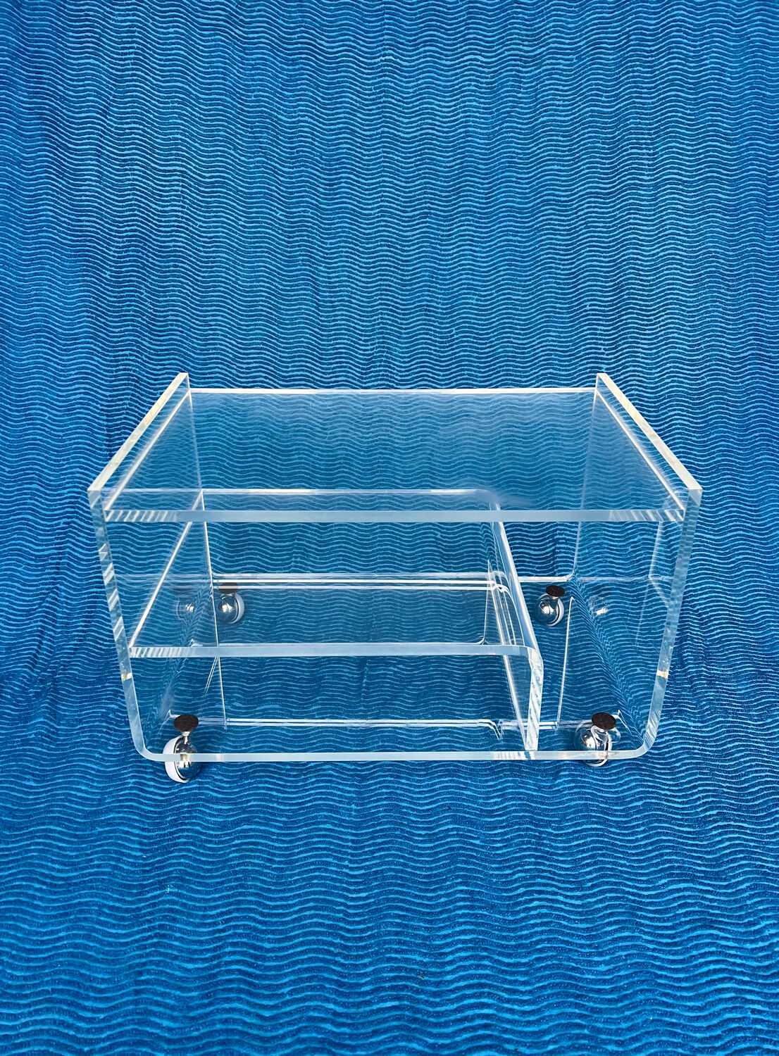 Translucent plexiglass storage drawer/cabinet on wheels.