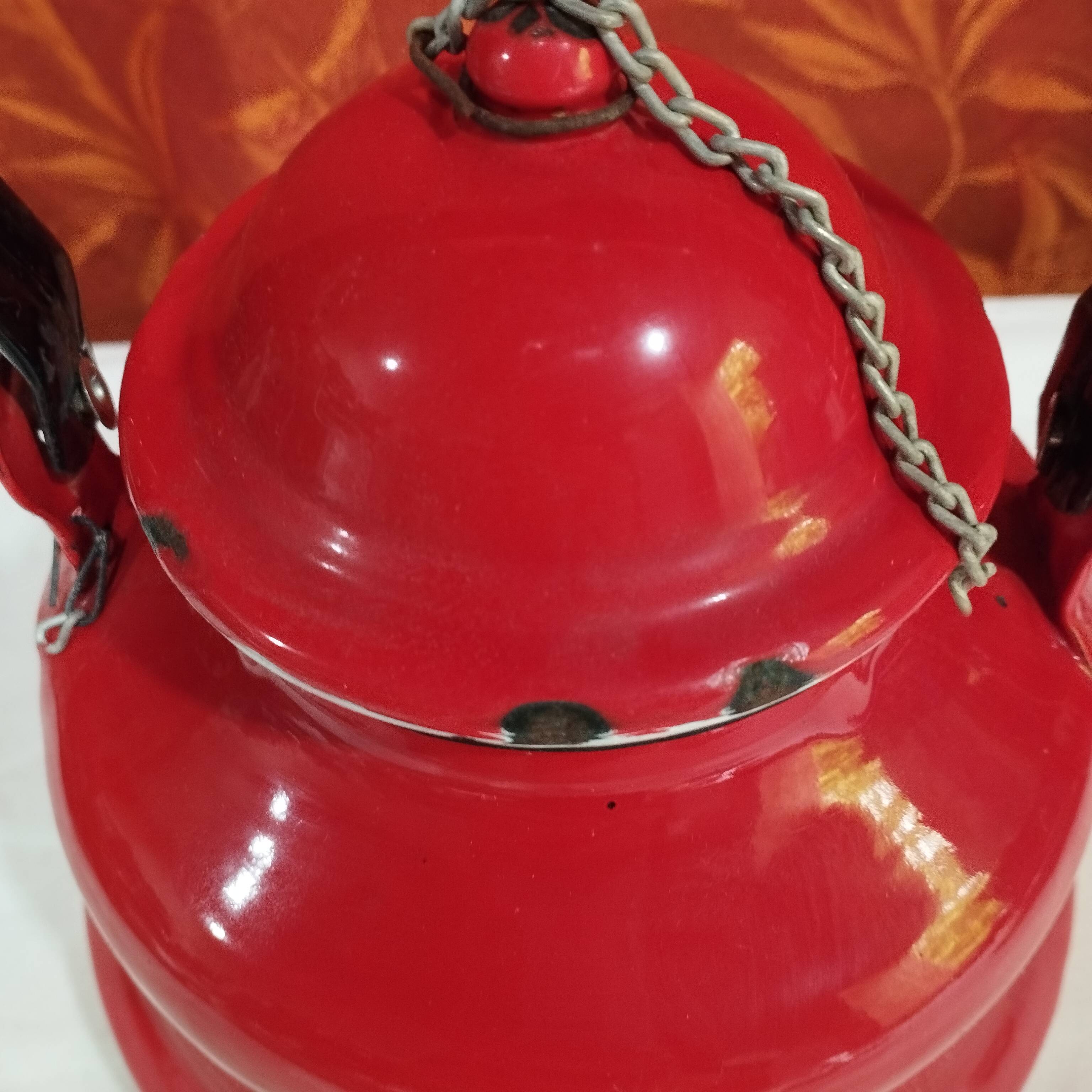 red enamelled sheet metal kettle