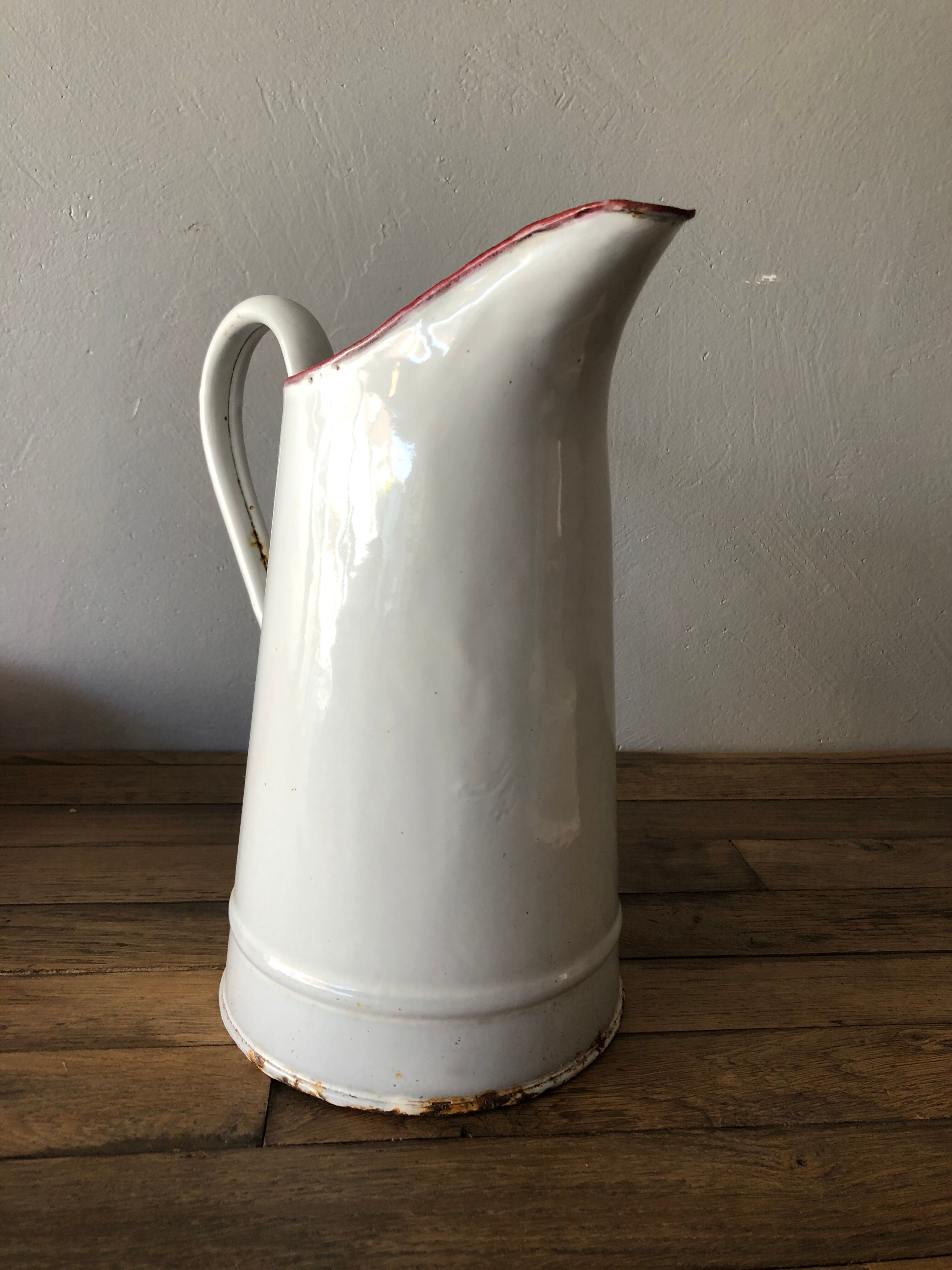 Old pitcher in enamelled sheet metal