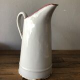 Old pitcher in enamelled sheet metal