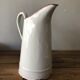 Old pitcher in enamelled sheet metal