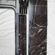 Pompadour fireplace with black marble modillions
