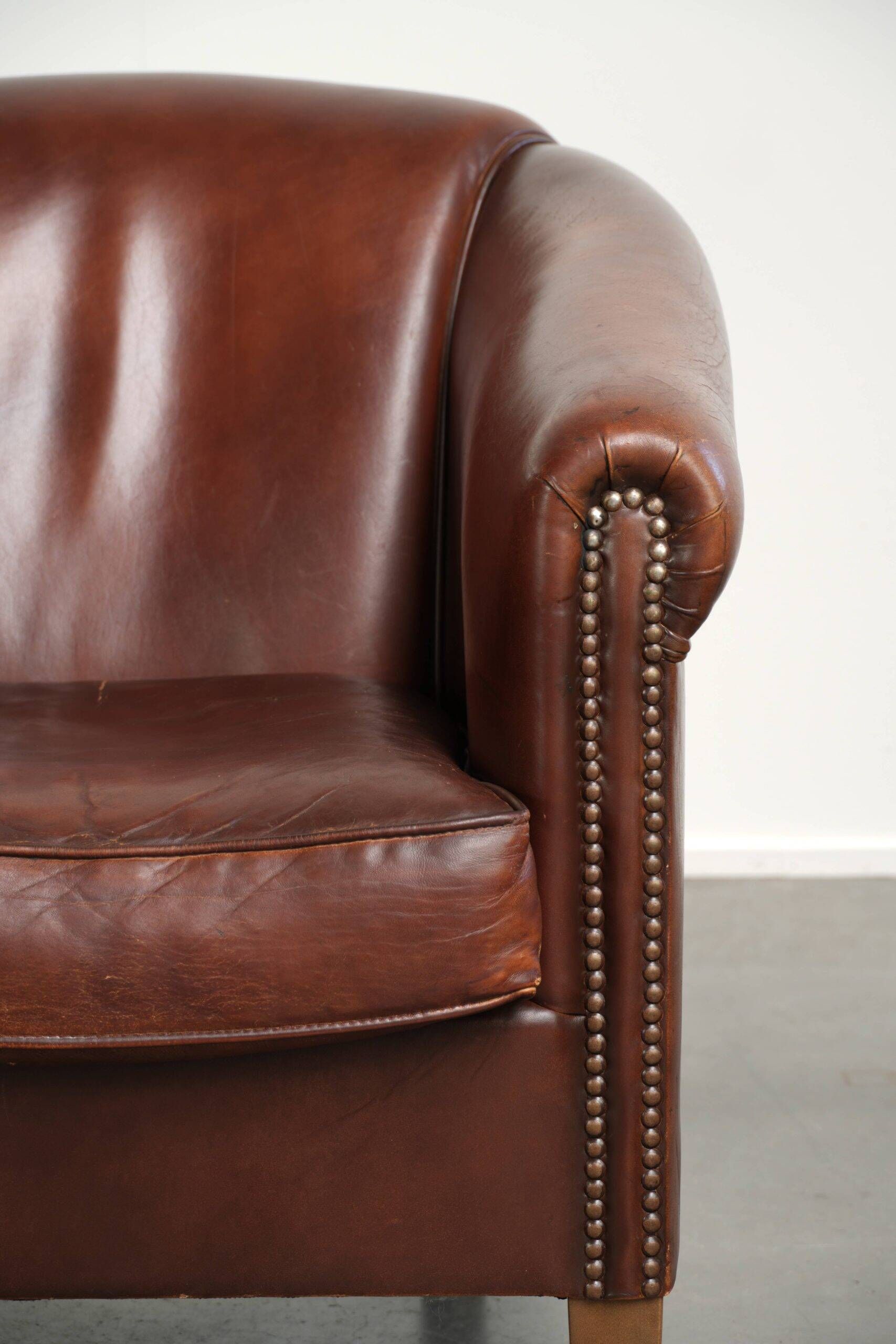 Sheepskin club armchair in English style with brown colour scheme