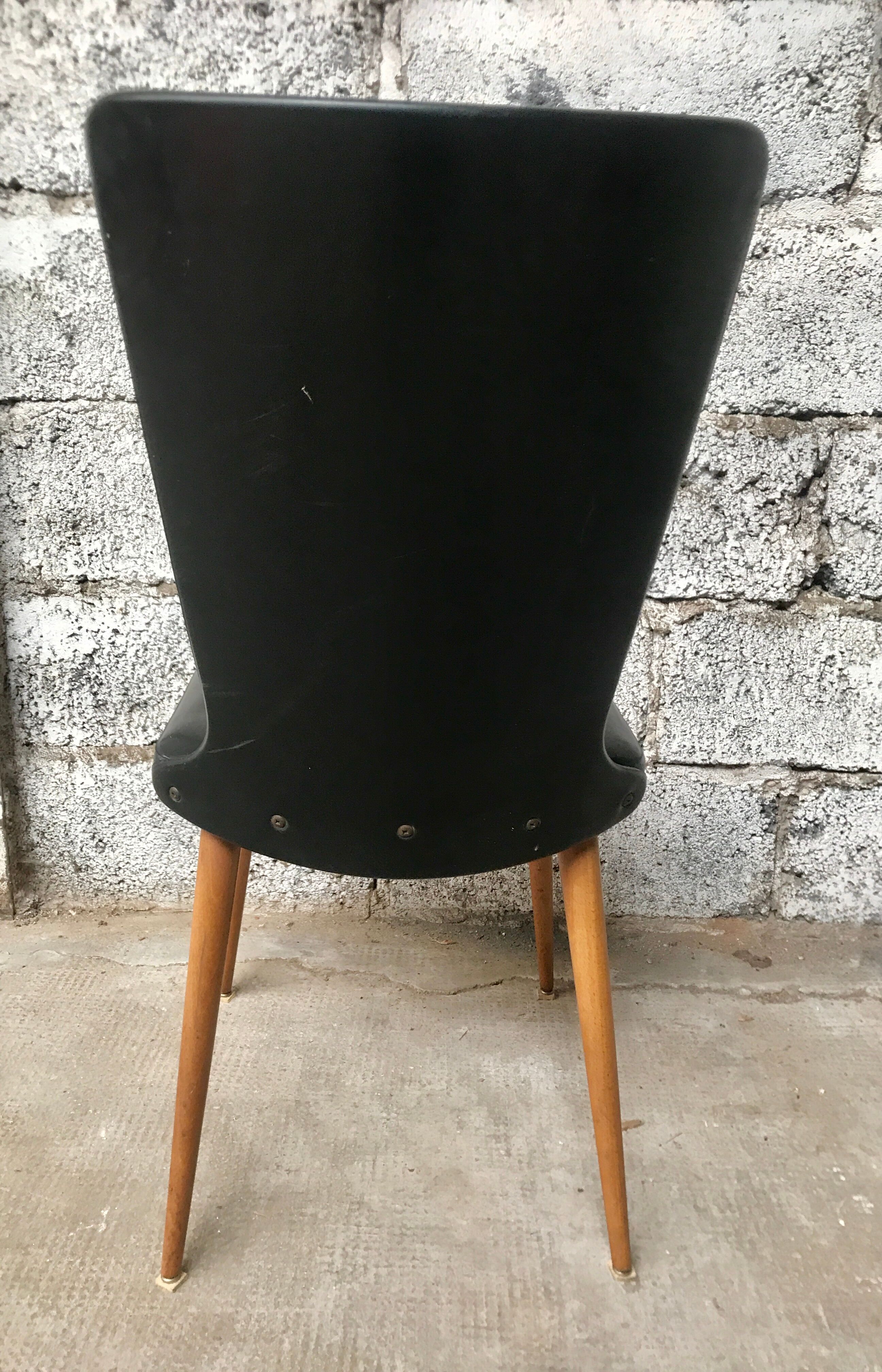 Pair of Baumann model Essor chairs in faux black leather, beech compass footing