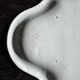 Antique oval-shaped white crackled faience plate with a scalloped edge.
