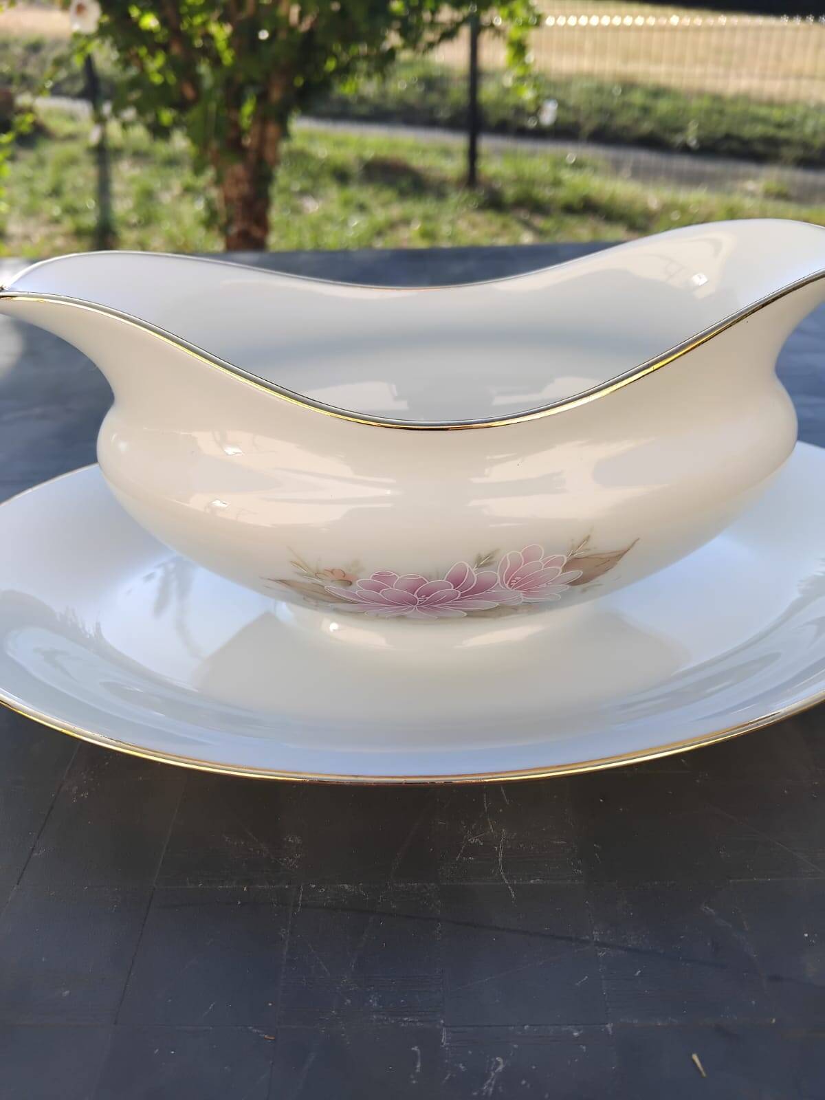 Vintage fine porcelain sauce boat with gold gilding.