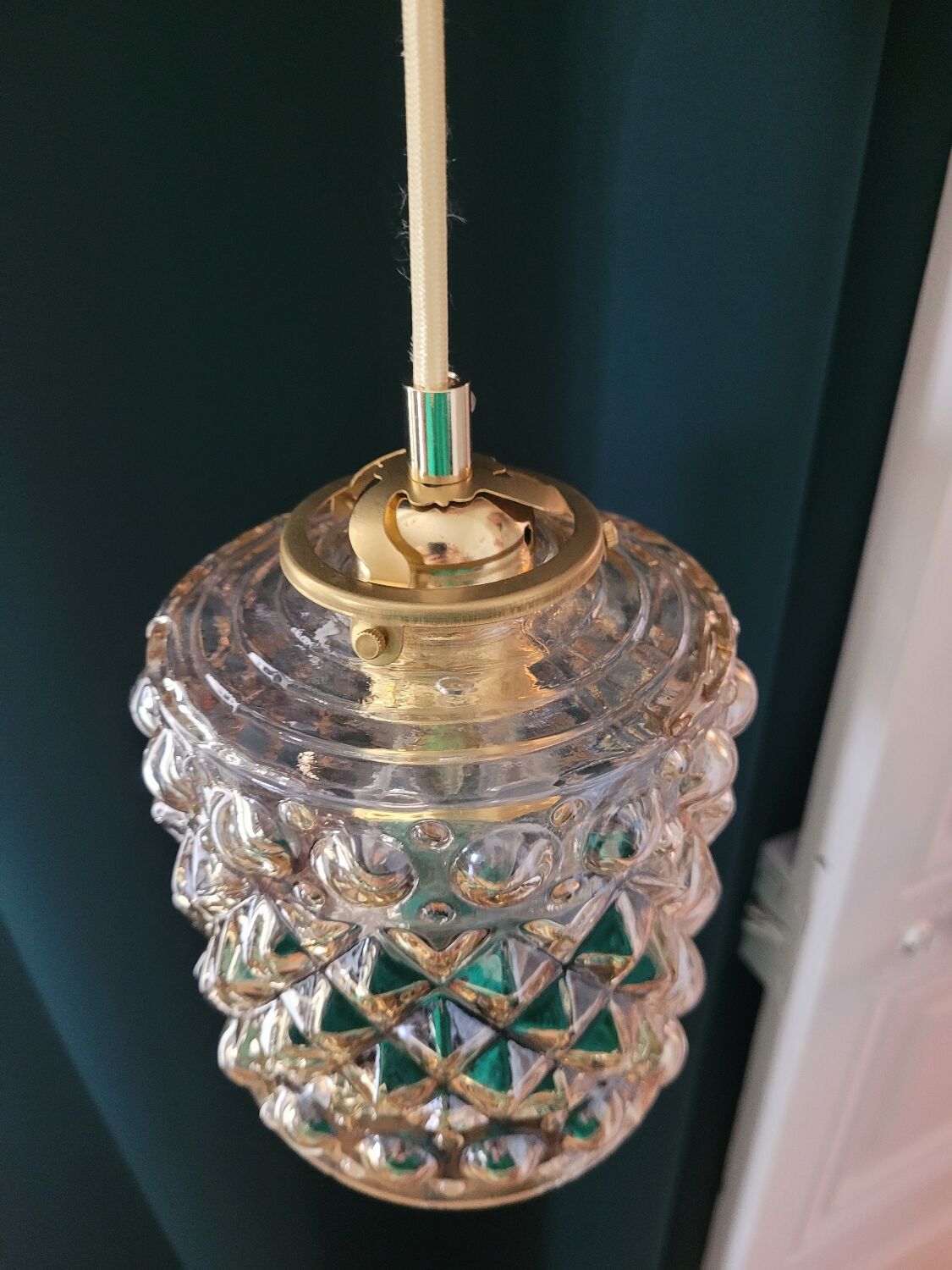 Moulded glass lamp with a cubic-spherical relief design.