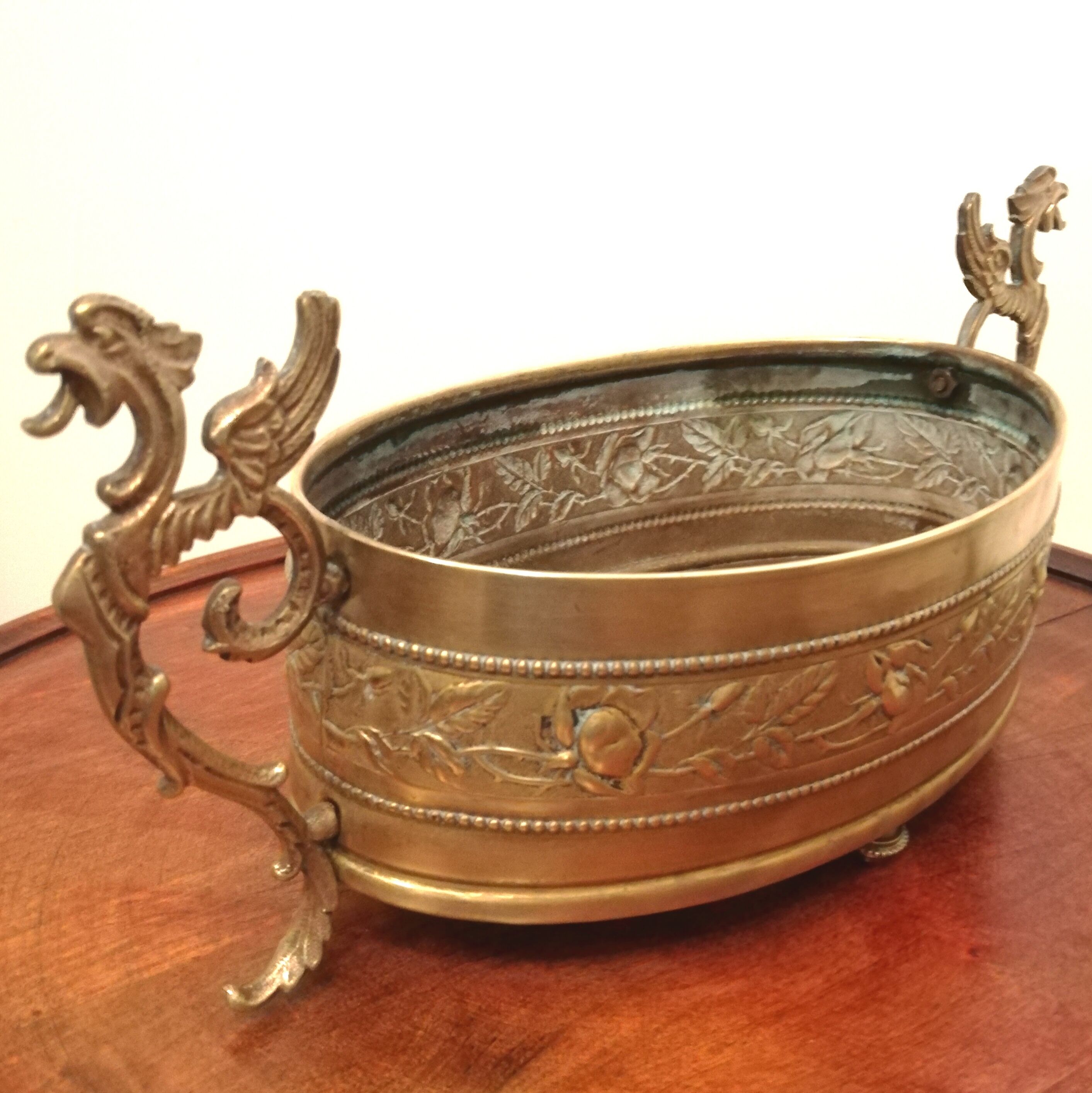 Repulsed brass planter with dragon-shaped handles
