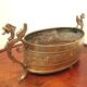 Repulsed brass planter with dragon-shaped handles