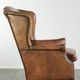Sheepskin wingback armchair with patina finished with decorative nails