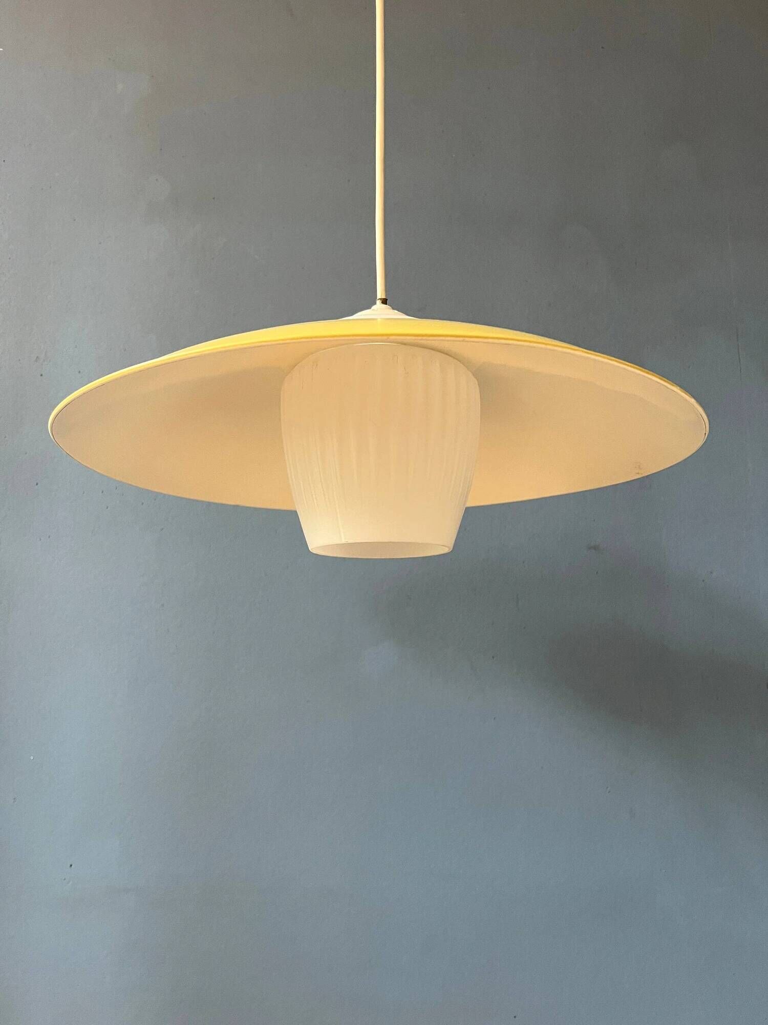 Danish mid-century suspension with opaline glass shade and yellow metal cover.