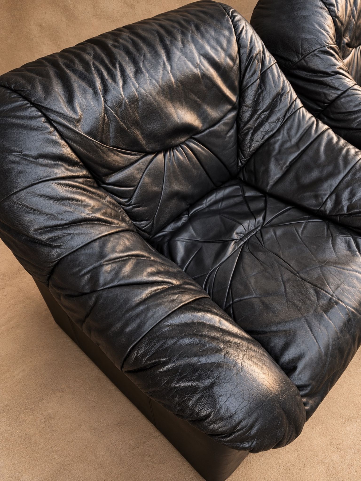 Leather armchairs and matching pouf, Italy, circa 1980