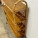 Vintage shelf on legs made of rattan and wood.