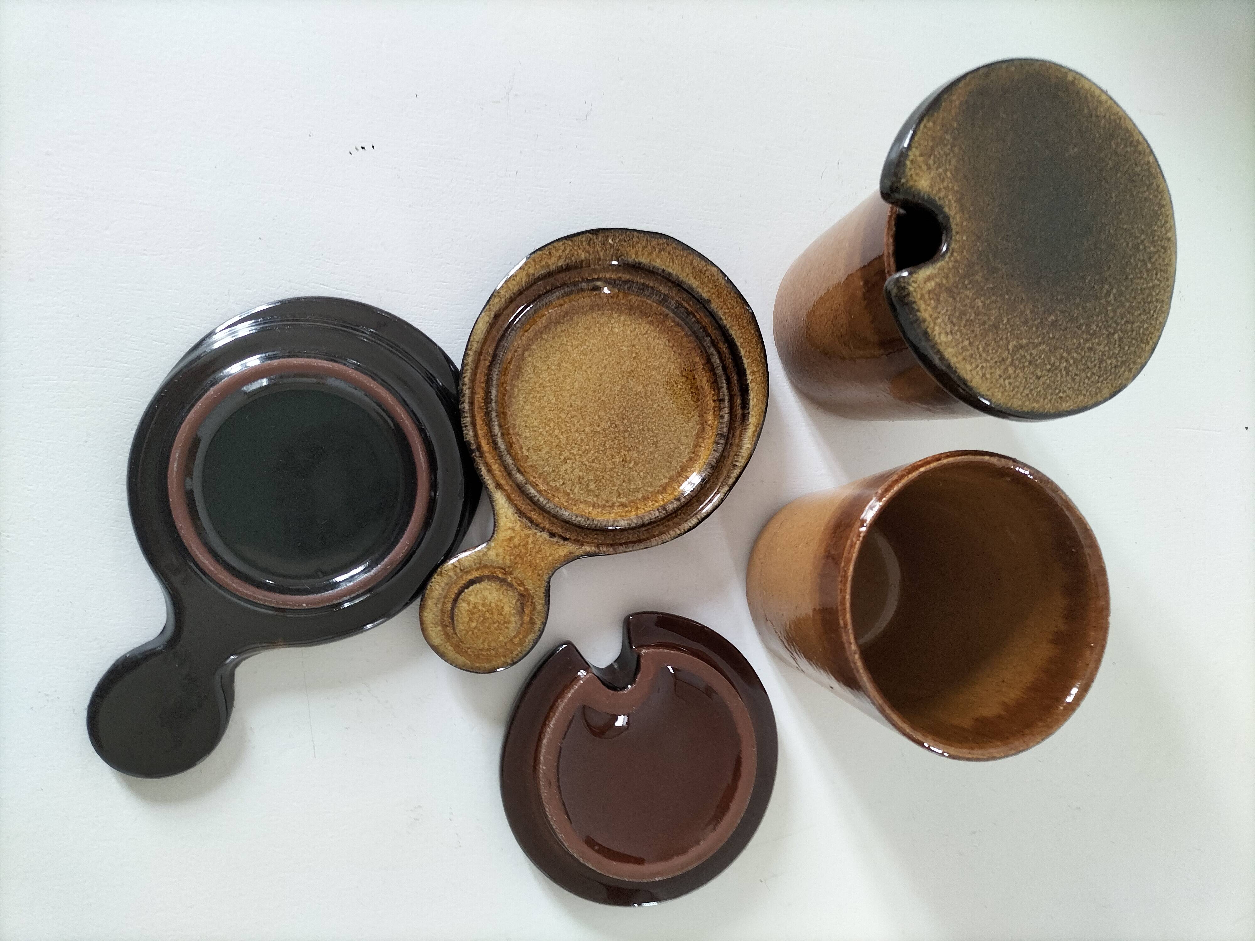 Pair of glazed stoneware cups with saucers and lids